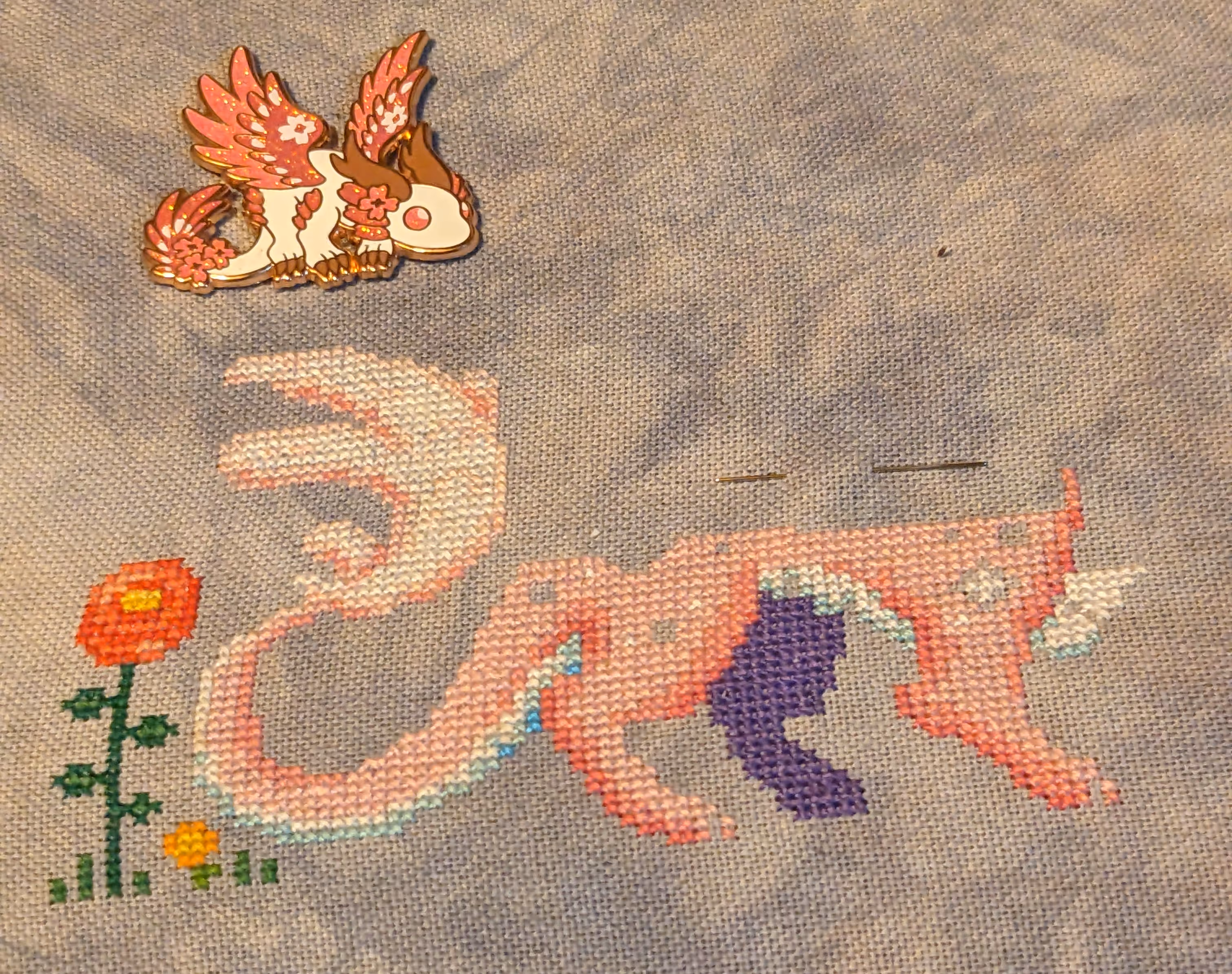 Image of a cherry blossom themed dragon in a meadow that is half way done.