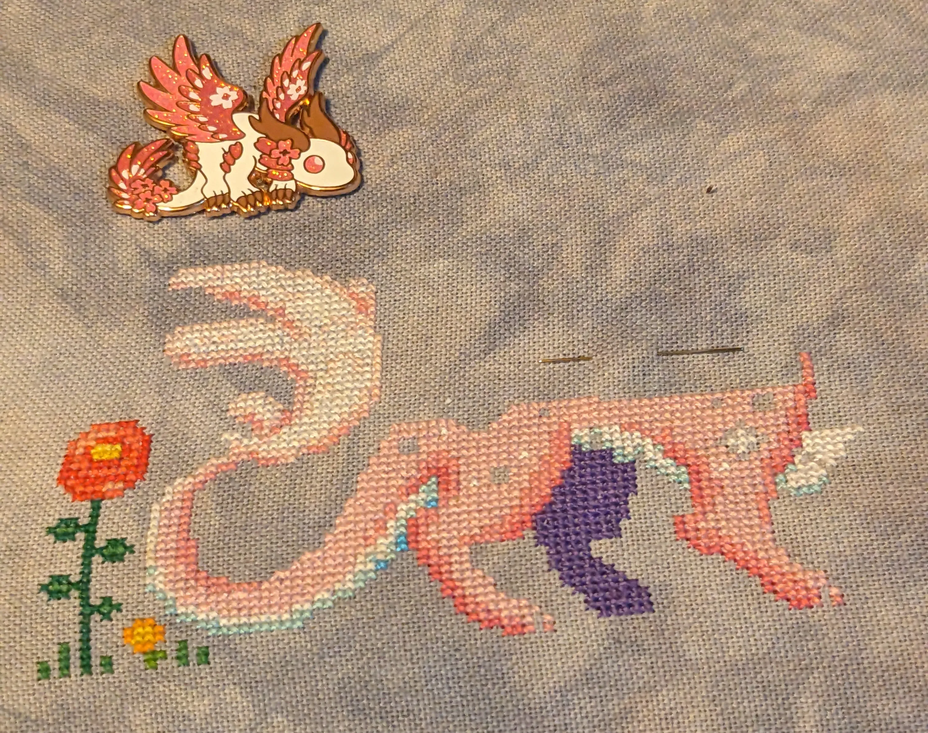 Image of a cherry blossom themed dragon in a meadow that is half way done.