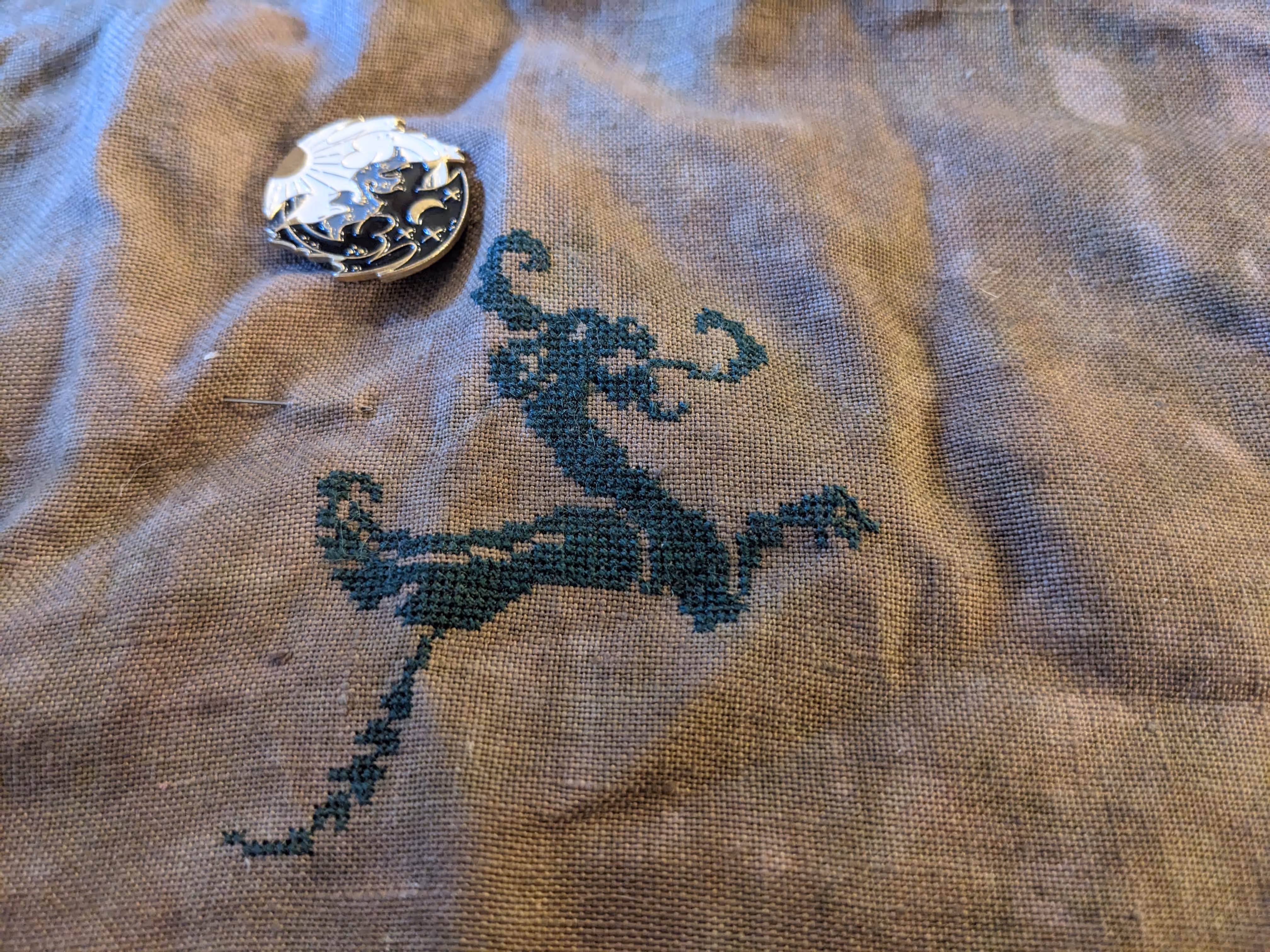 Image of a Quaker style cross stitch sampler whose subject matter is dragons