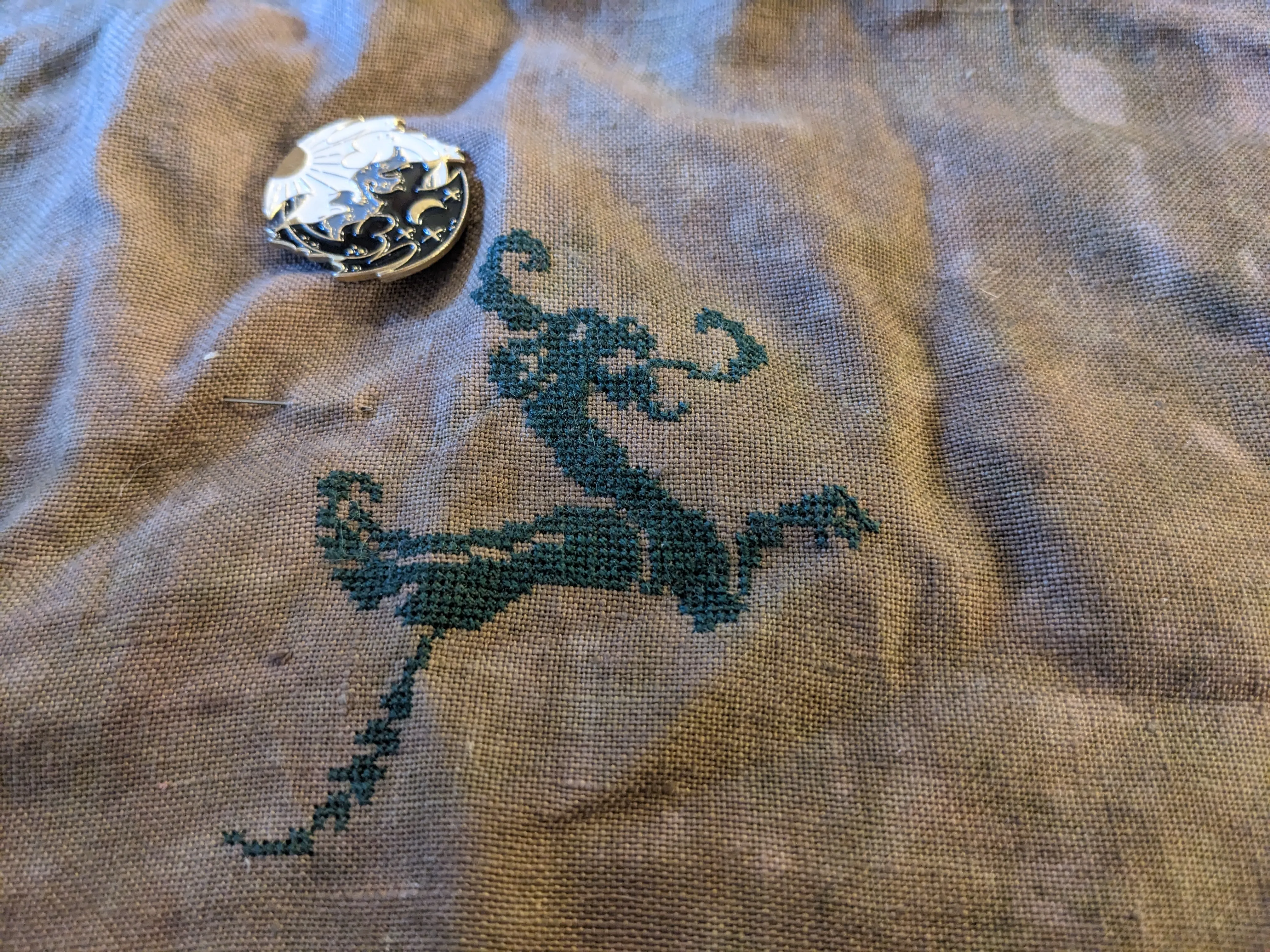 Image of a Quaker style cross stitch sampler whose subject matter is dragons
