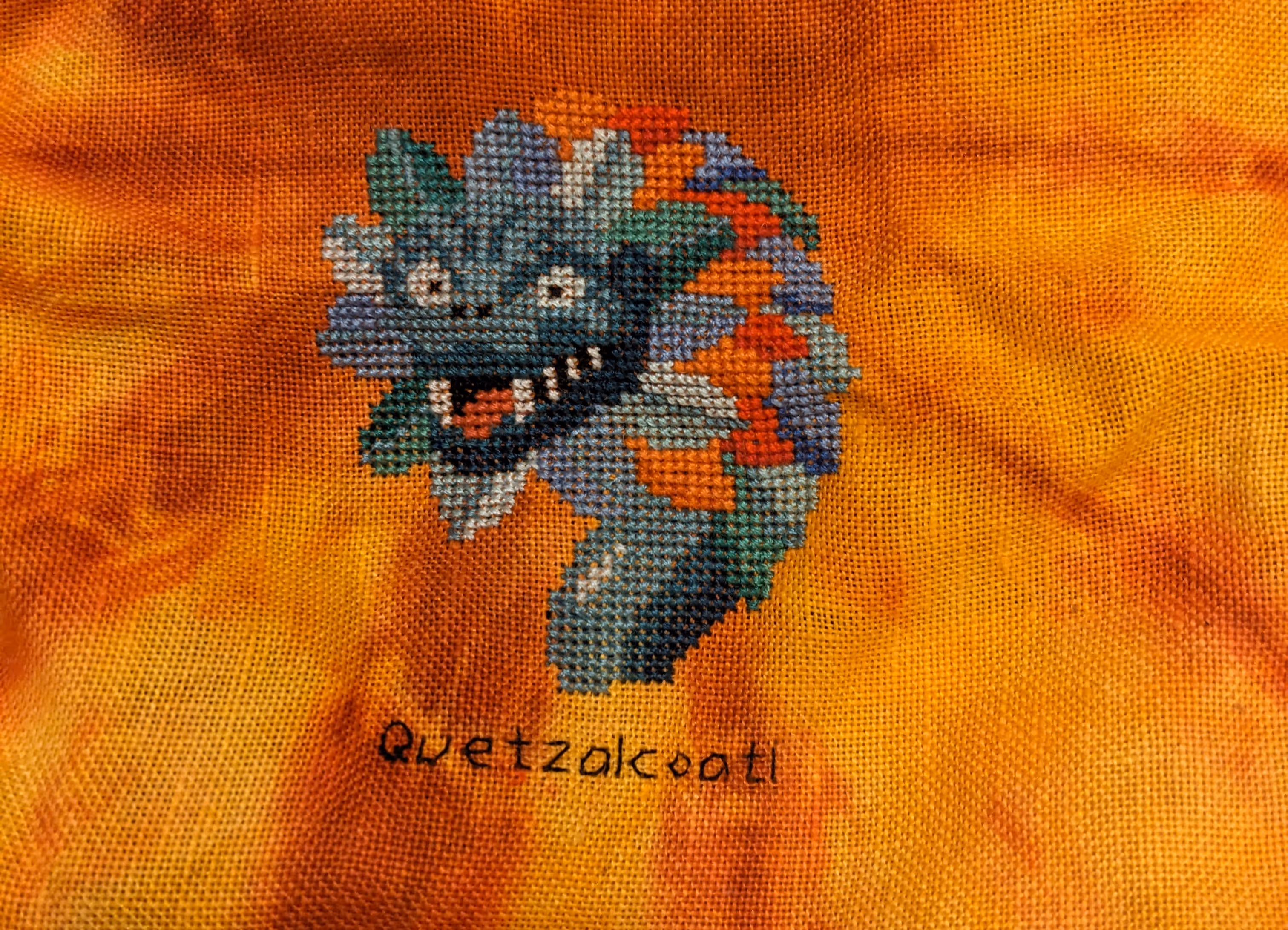 The head and mane of a multi-colored dragon in blues, reds, and oranges