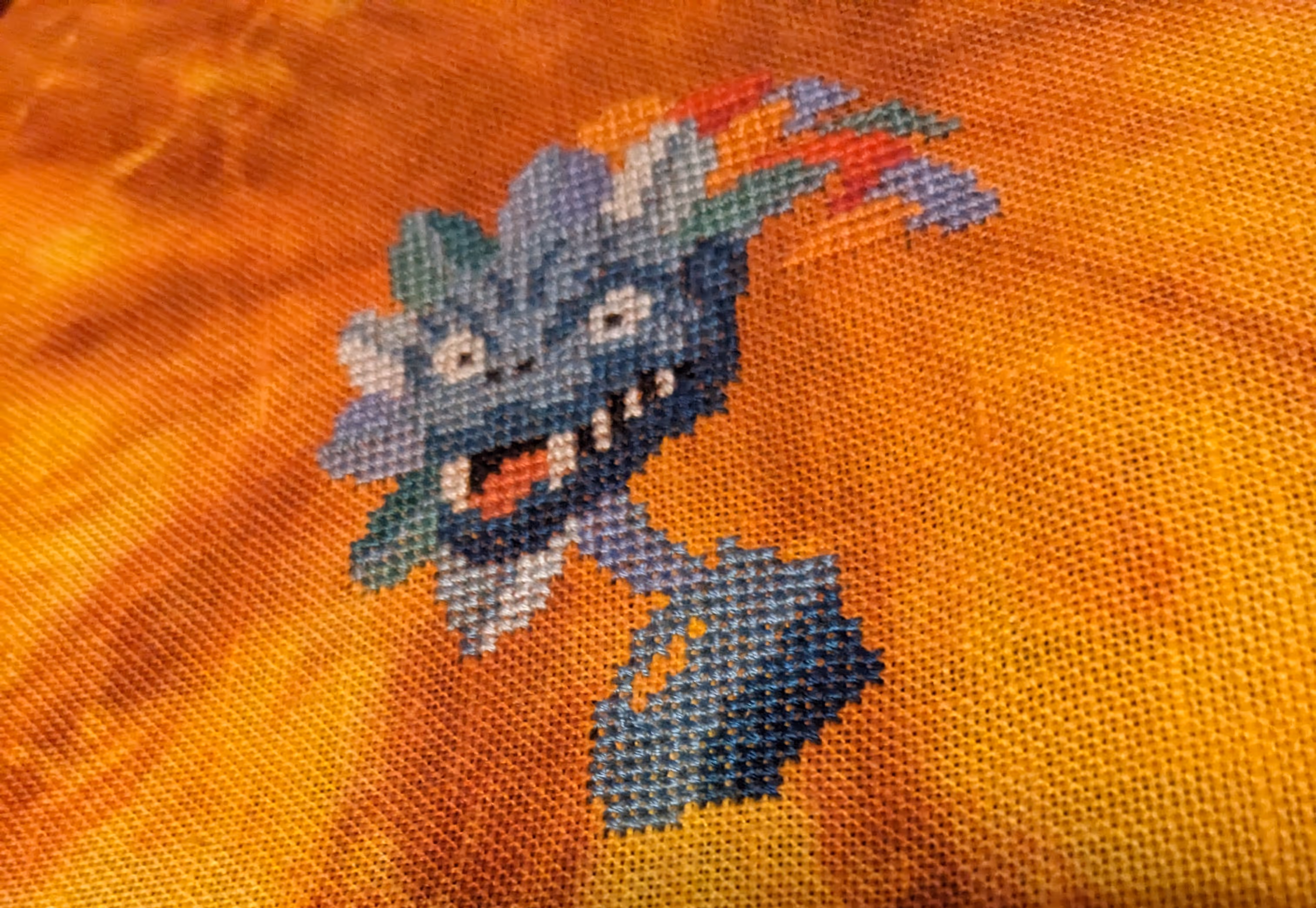 The head of a dragon with a multicolored mane