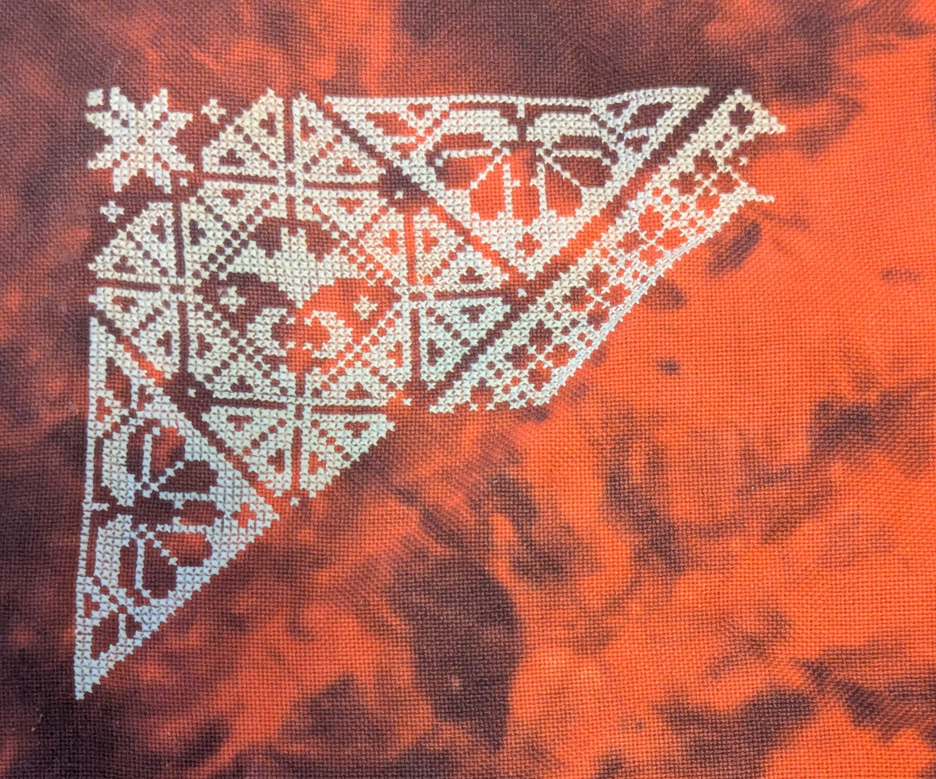 A monochrome pattern in white featuring bats on a blood red fabric