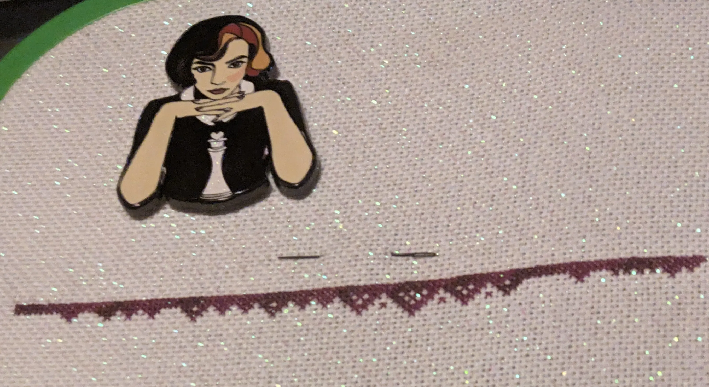 image of a border in red variegated silk thread on white opalescent fabric