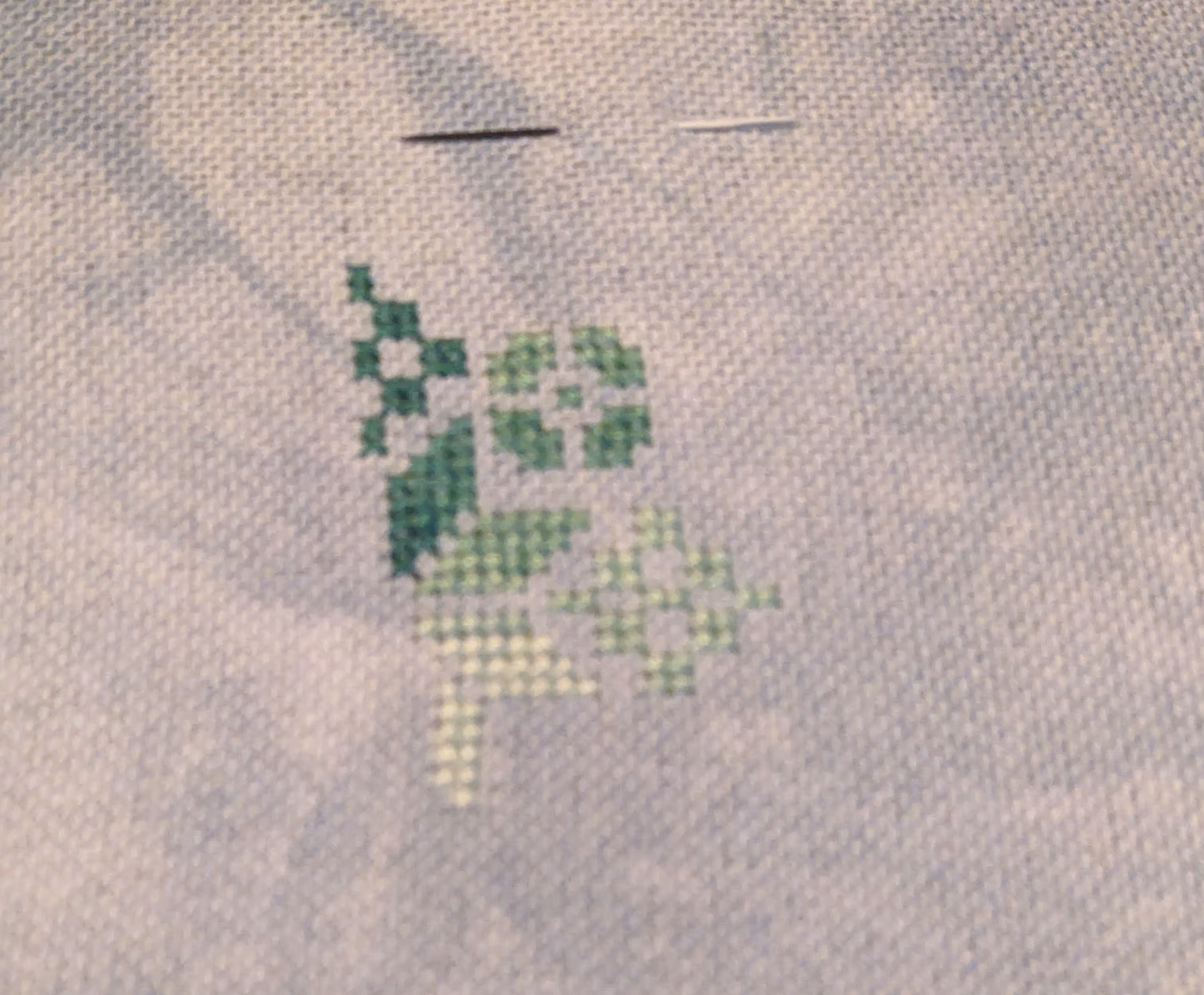 image of cross stitch in shades of green of a geometric Quaker motif