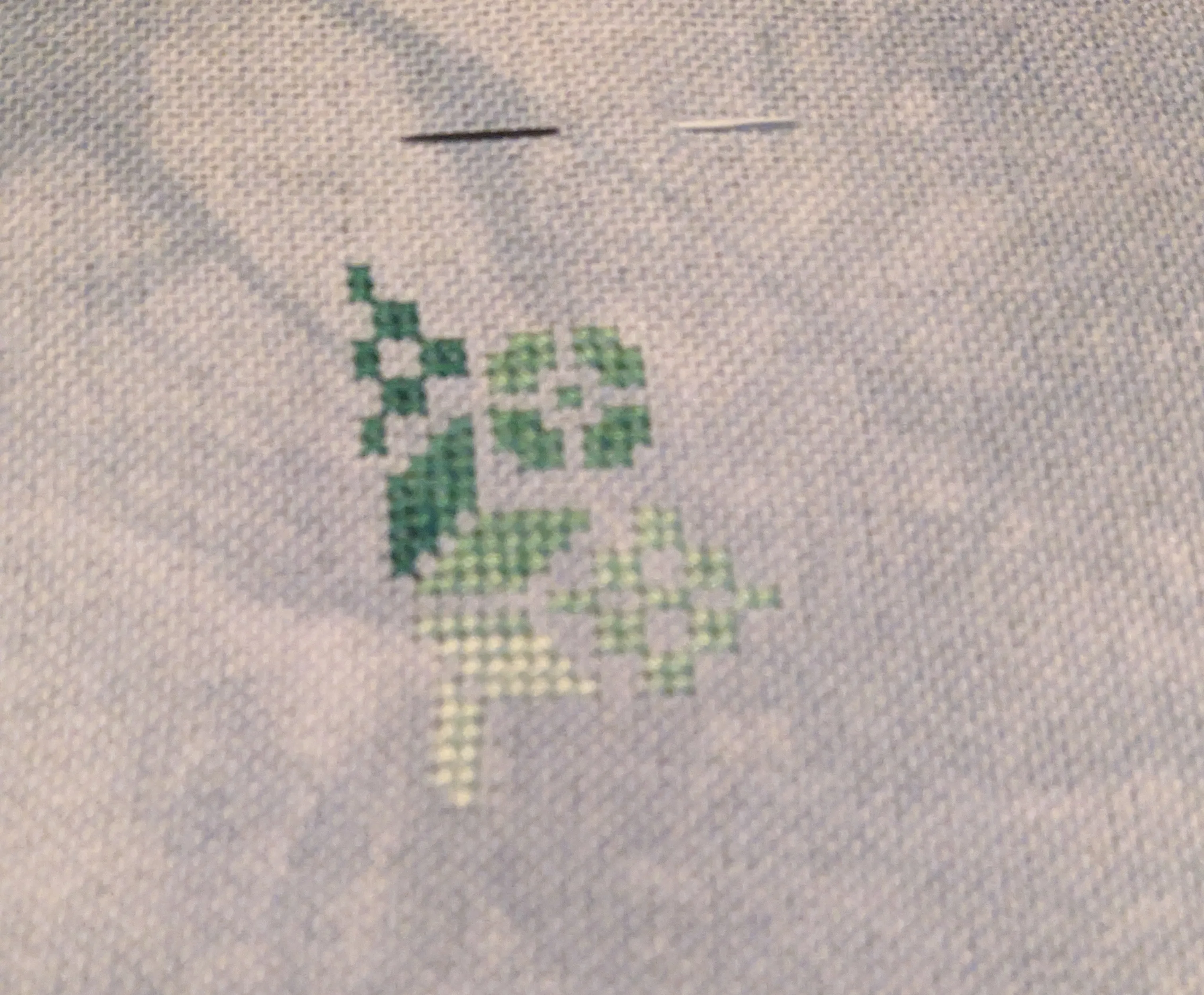 image of cross stitch in shades of green of a geometric Quaker motif