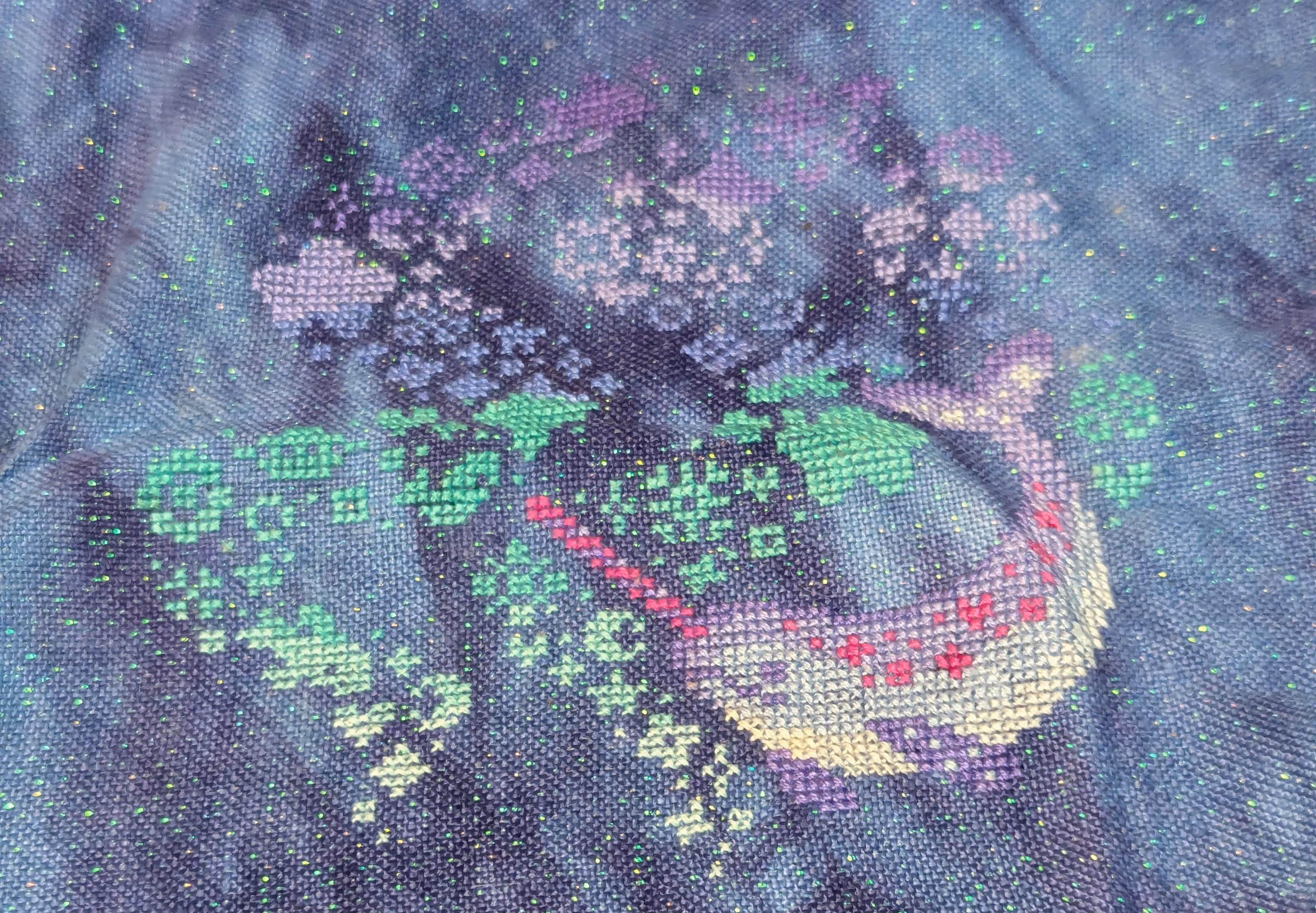 A narwal is featured in the colors of purple and magenta the background looks like a Lisa Frank with a gradient from dark purple to light green