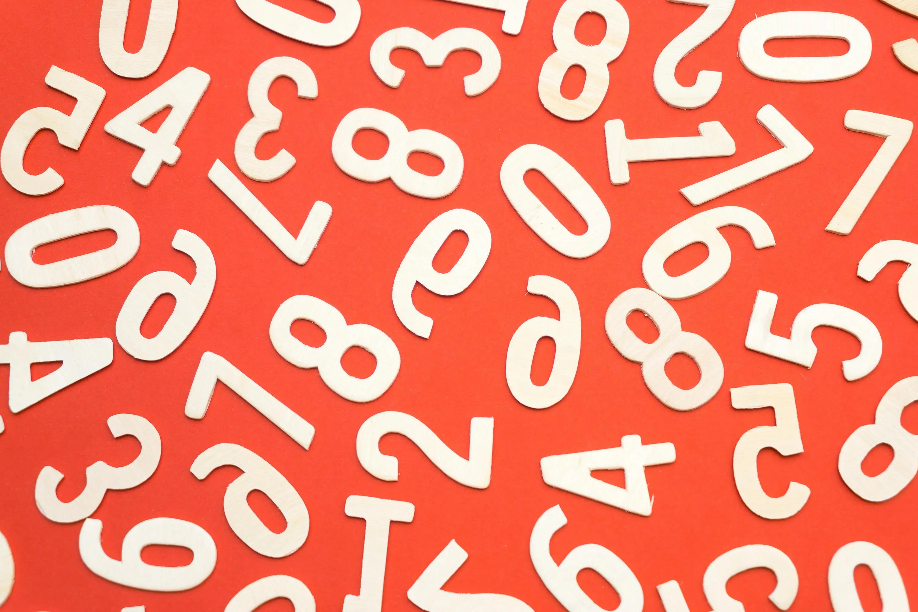 Image of a jumble of digits from zero to nine on an orange background