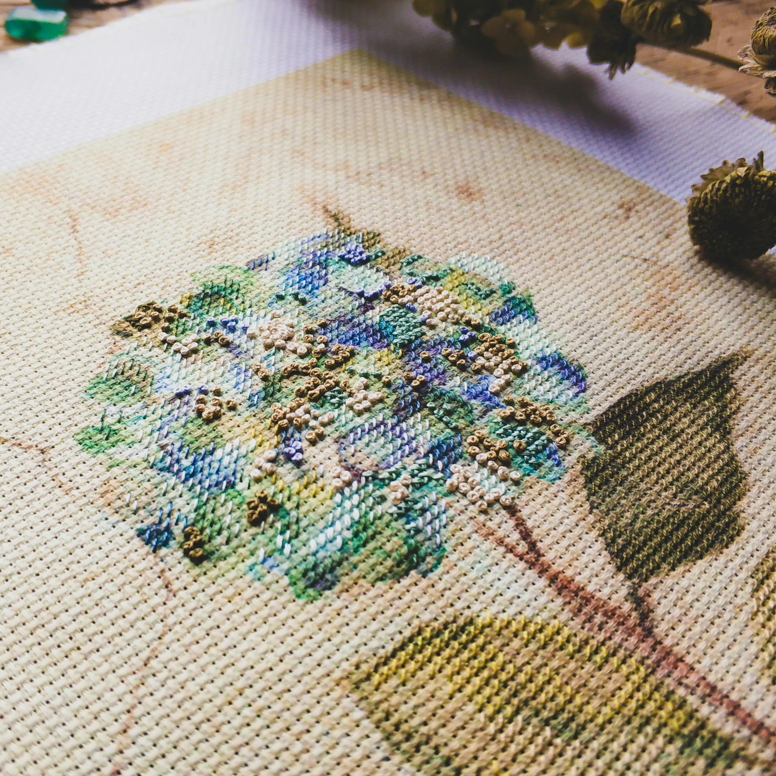 A cross stitch of a blooming flower