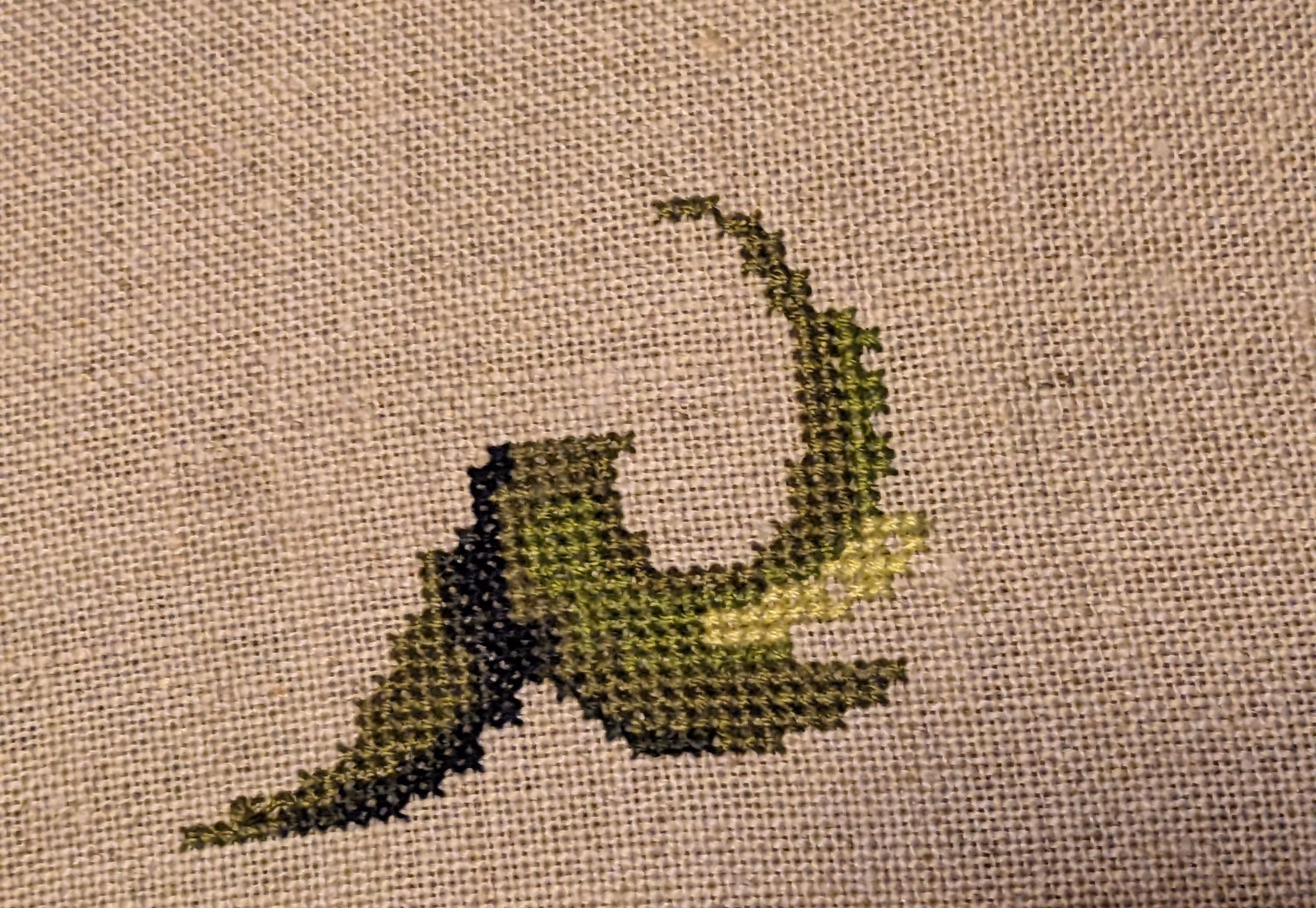 A Ursula like sea witch stands tall in shades of green.