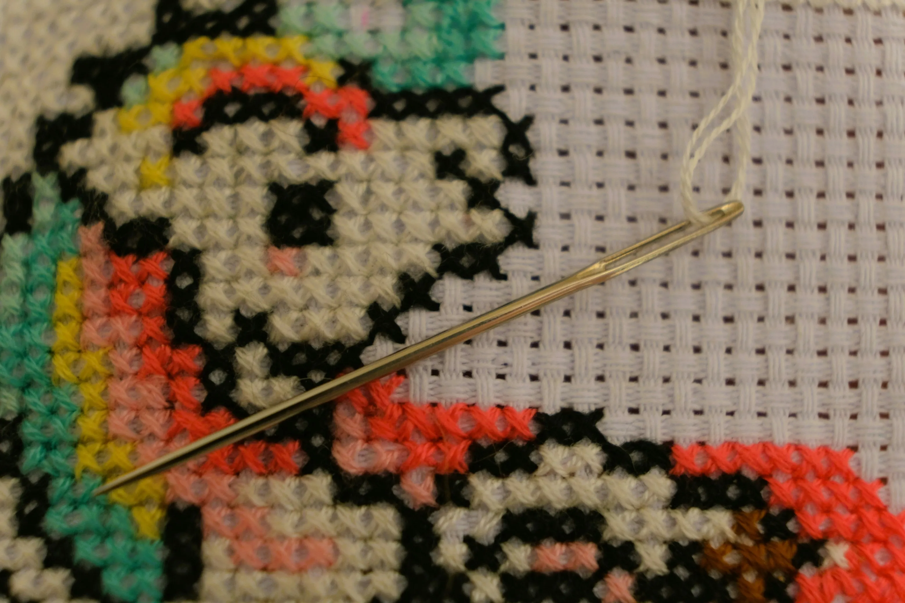 an image of a unicorn in bright thread on a white background in cross stitch 