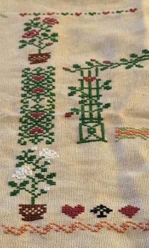 A fence is surrounded by hearts, spades, clubs, and diamond and the white rabbit is featured in the top left corner