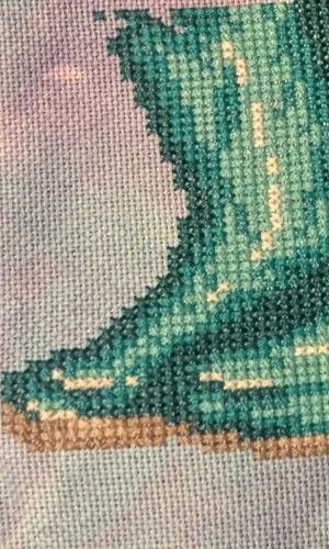 The start of a pair of teal boots partially completed