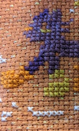 A black cat in over sized rain boots of orange and yellow splashes in a puddle while singing with musical notes